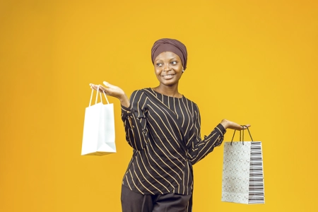 Femme présentant des sacs de shopping