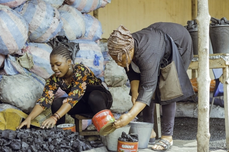 Une vendeuse de charbon et son enfant au marché