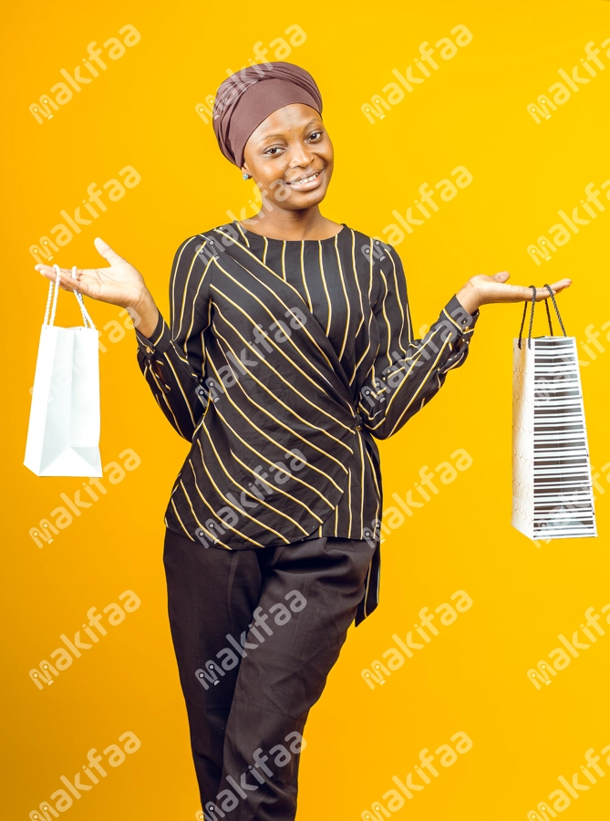 jeune fille souriante tenant des sacs de shopping