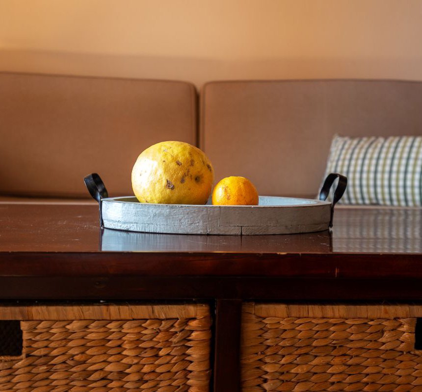 Fruits on the top of a coffee table with the sofa in the background