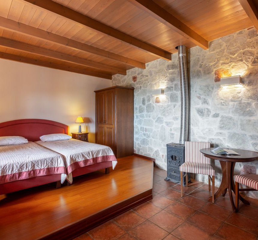 The interior of the residence with the modern design, the table and chairs, the white walls and wooden ceiling