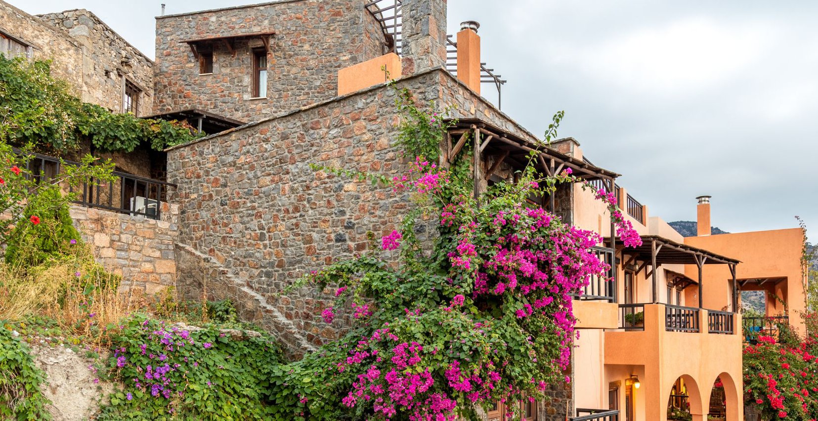 The exterior of Mala Villa with the greenery around the balconies