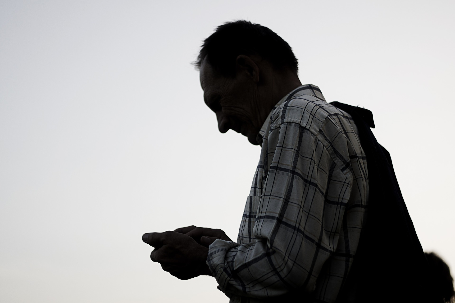 remote monitoring systems blog header image shadow of a man on phone