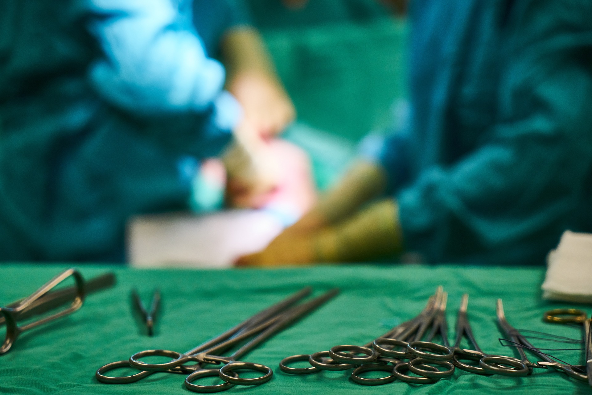 operating room HVAC blog header image medical tools on table with doctors in background