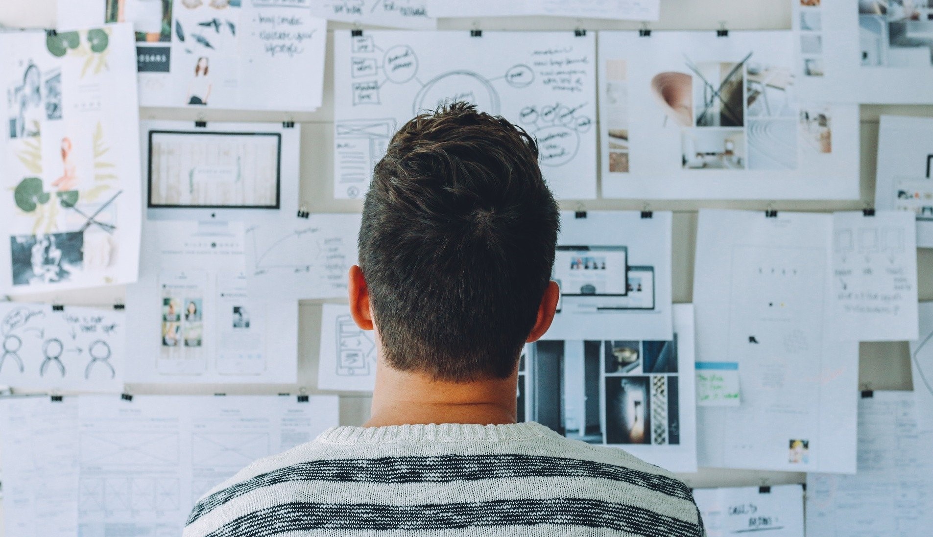 A man staring at a full whiteboard, demonstrating how an Energy Service Company or ESCO builds efficiency projects