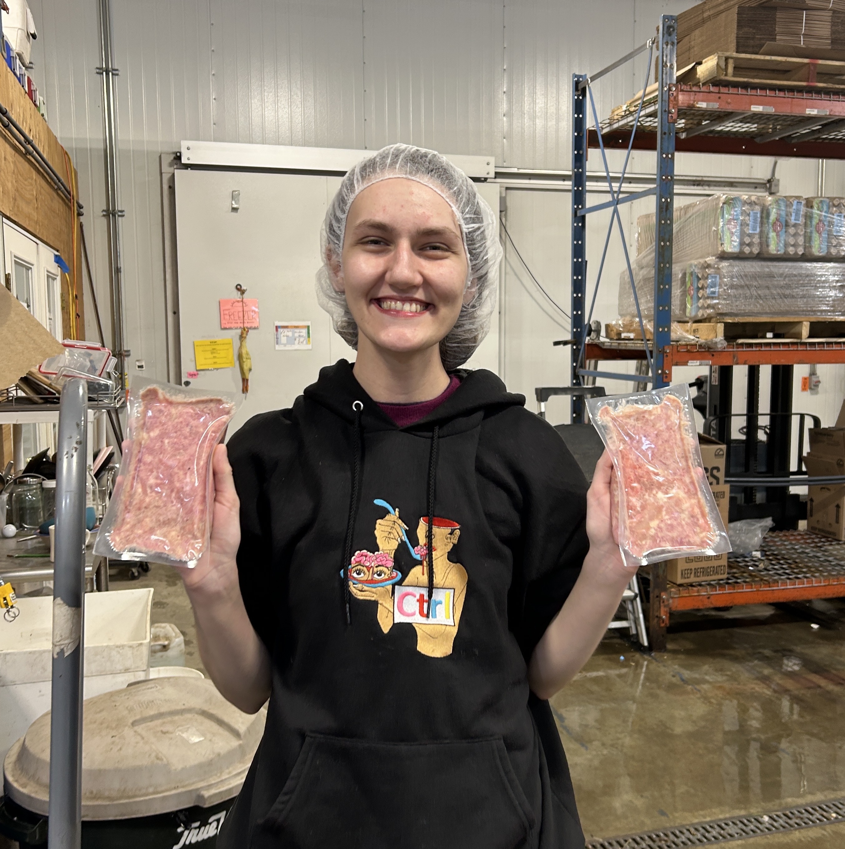 Shawna holding the first trial packages produced on the new roll-stock machine