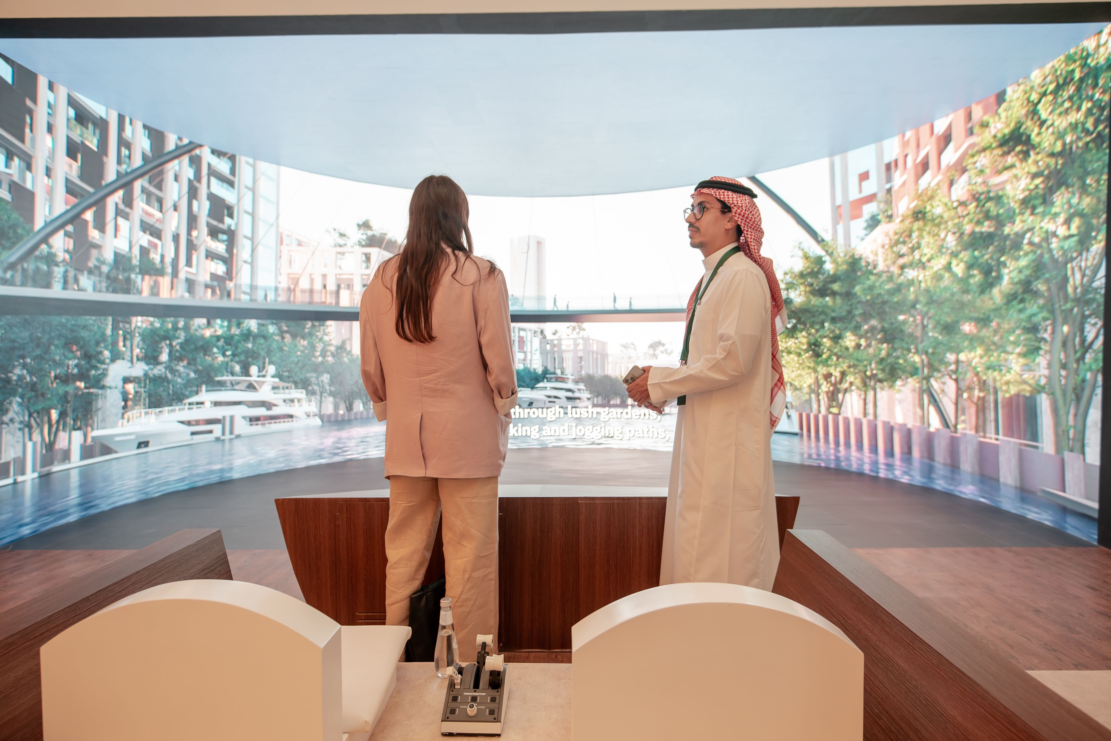 Two people engaged in a discussion about ROSHN Group projects