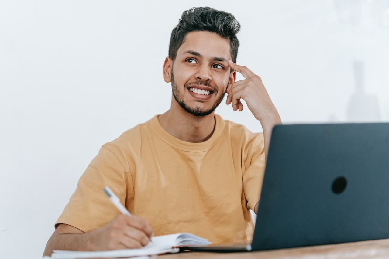 A man sitting at a desk and thinking