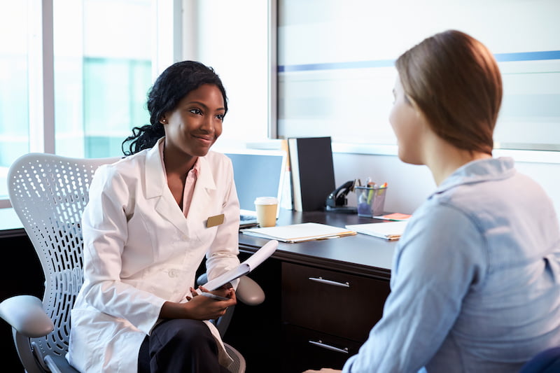 Female immigration attorney consulting with client in modern office setting
