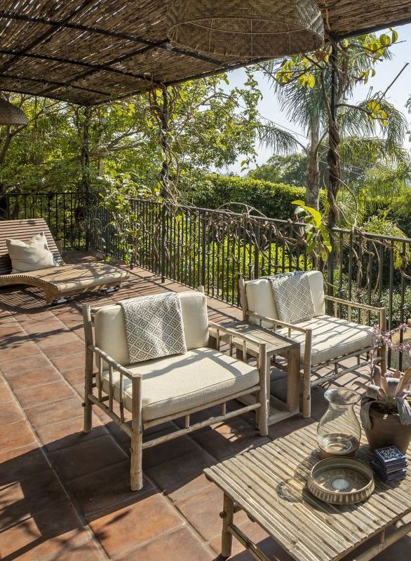 covered tile patio with table and chairs