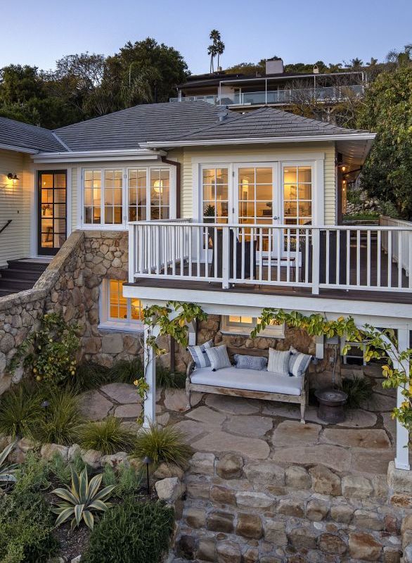 outside deck and overhanging stone patio and seating