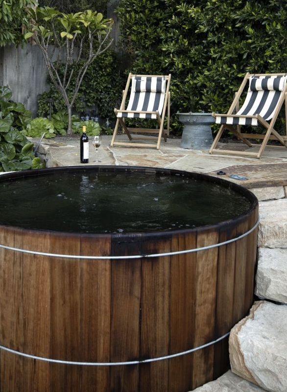 large wood hot tub and chairs