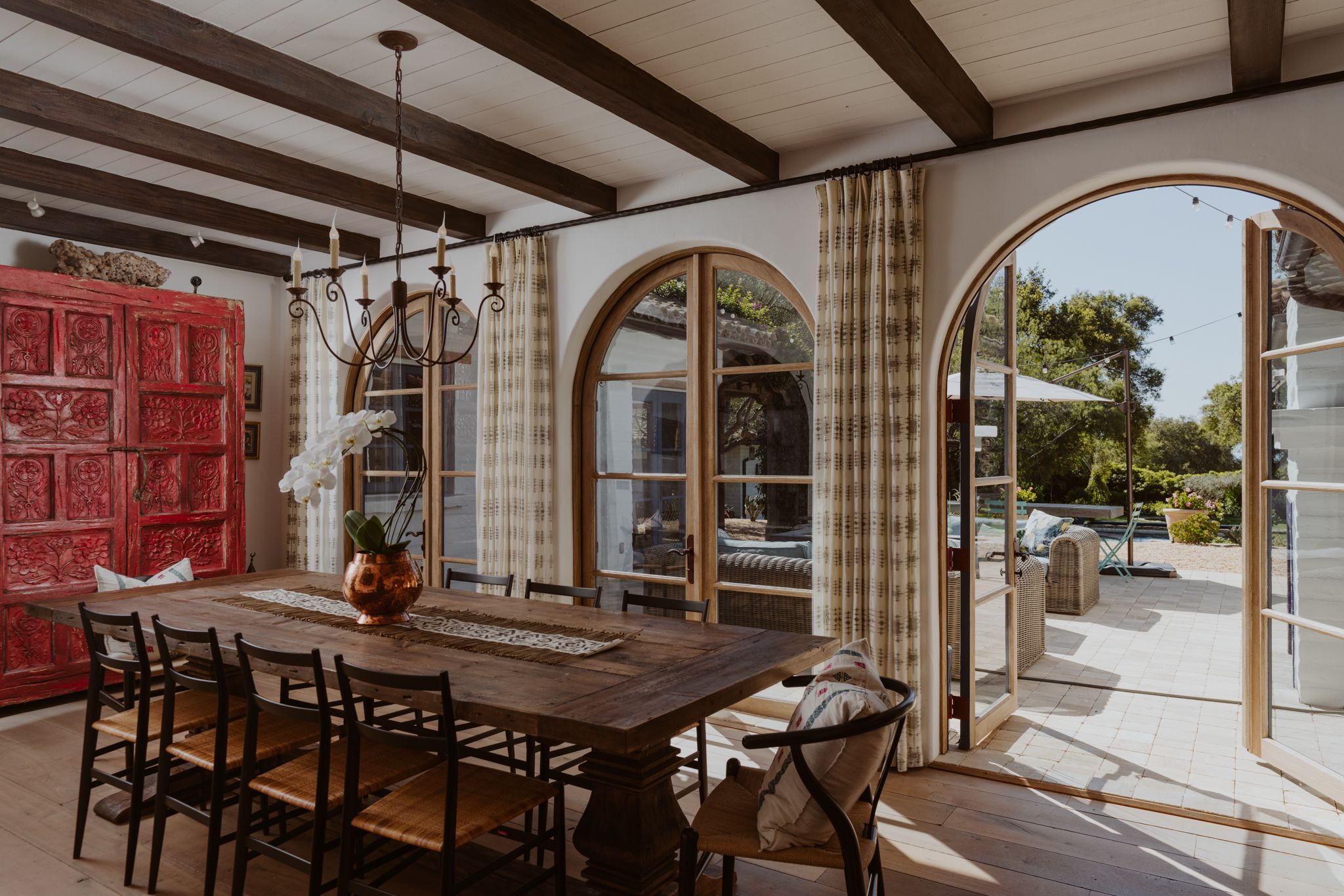 dining room table with large windows overlooking patio