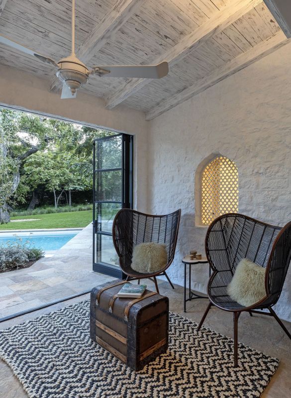 sitting area with open doors overlooking pool