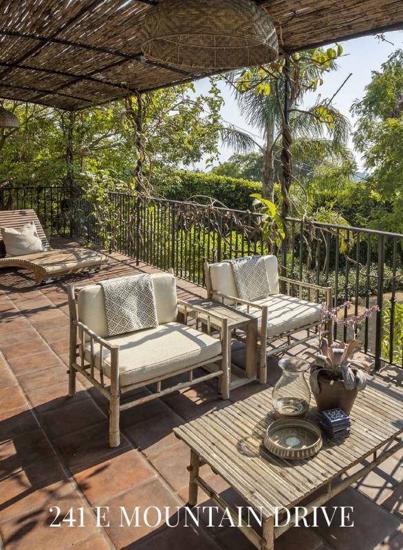 covered tile patio with seating and table