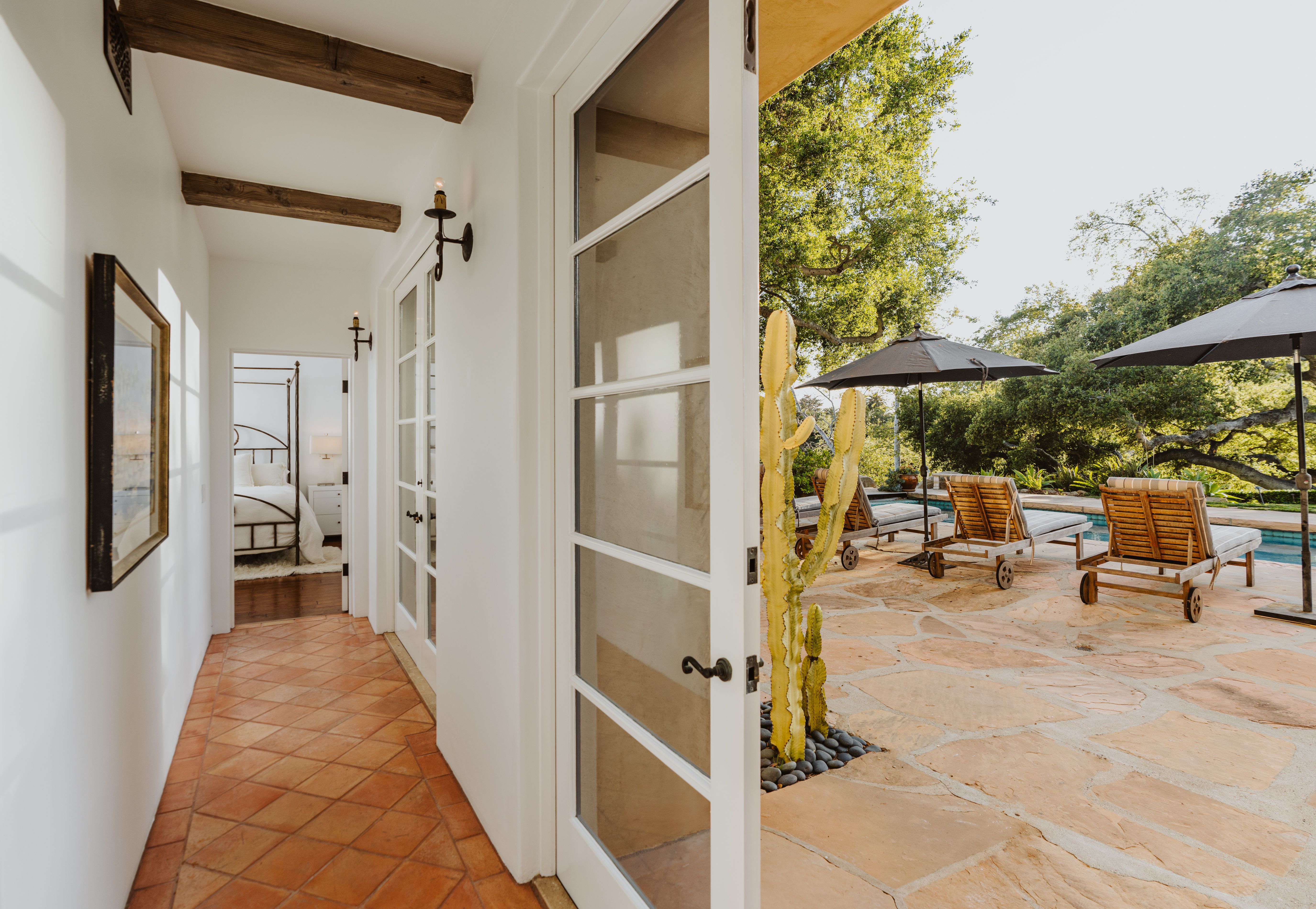 indoor hallway with views of outside pool