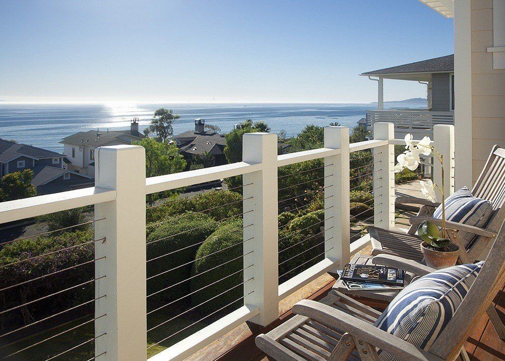 chairs sitting on backyard porch with view of ocean