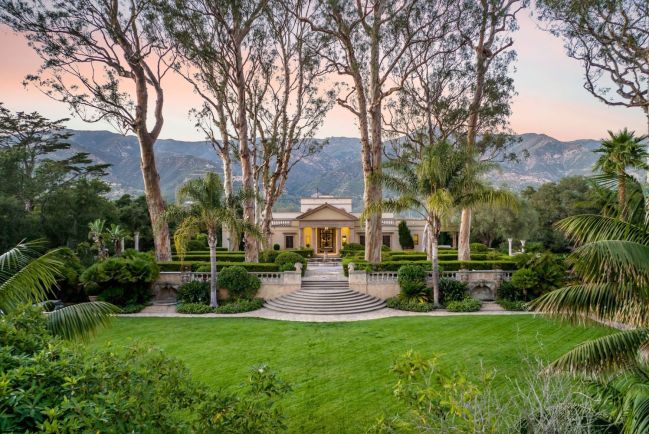 Sprawling lawn with steps leading to beautiful home