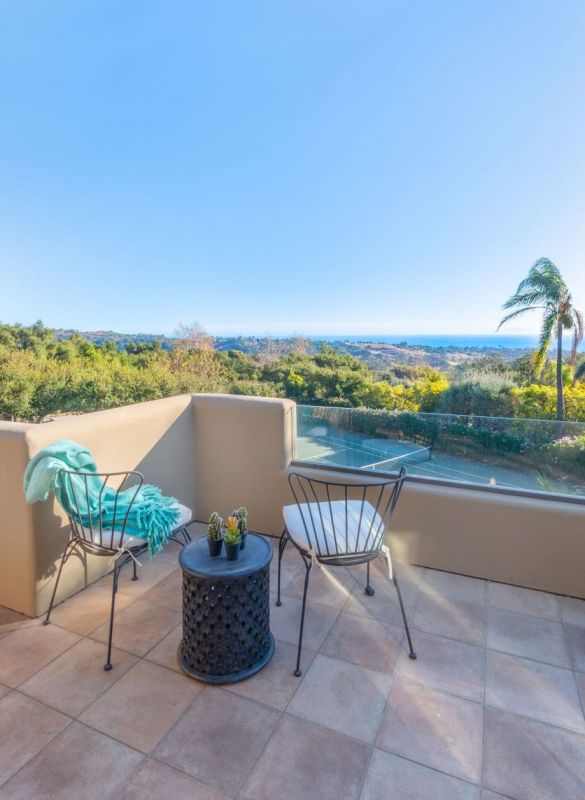 outside sitting area overlooking tennis court