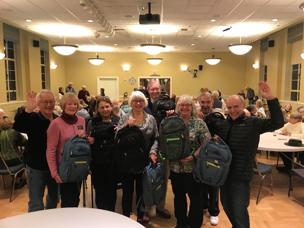 Group of seniors holding backpacks