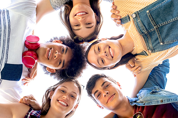 Teenagers hugging in a circle