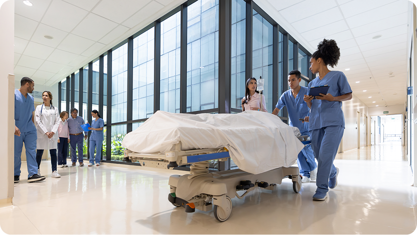 Healthcare workers moving a patient