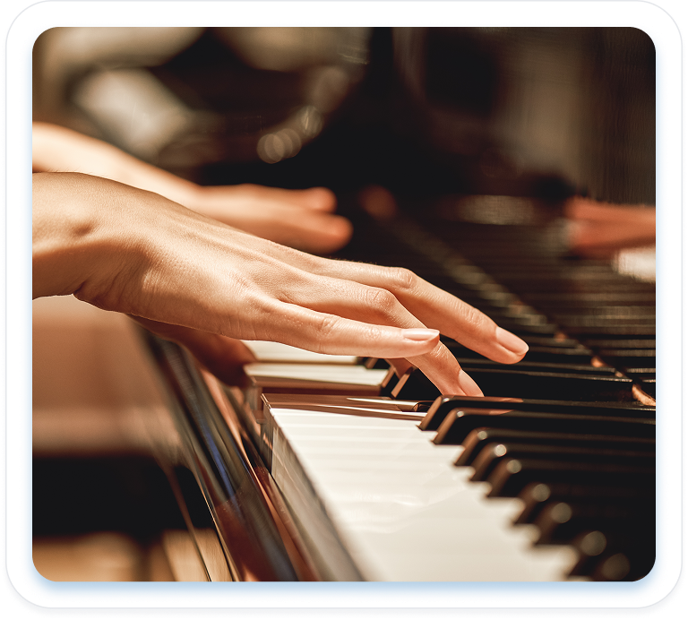 Close-up of a person's hands playing the black and white keys of a piano.