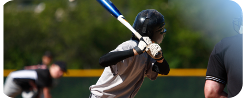 Young baseball player ready to hit the ball with a bat