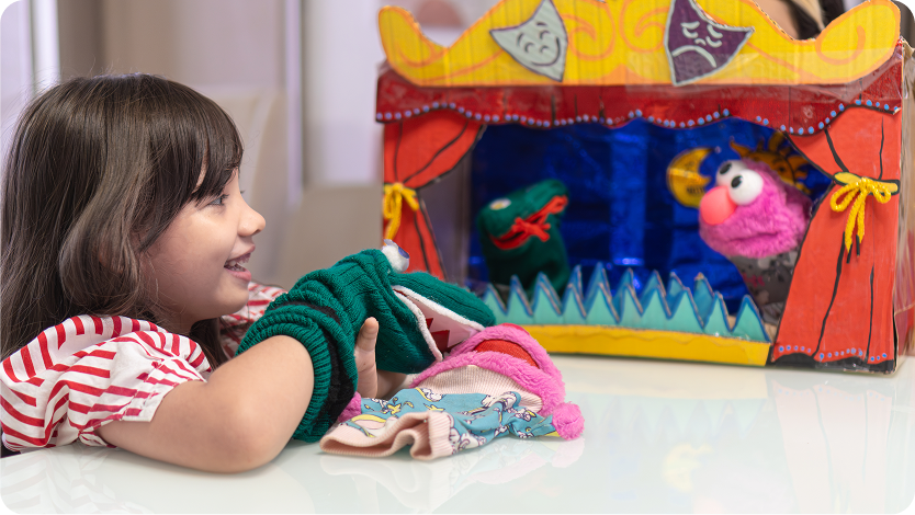 Little girl delighting in puppet play