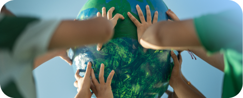Young kids holding a green earth globe