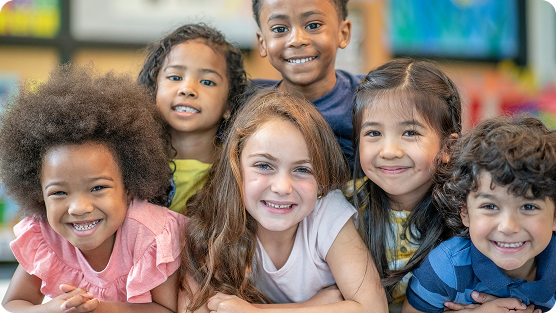 Group of smiling young kids in a classroom