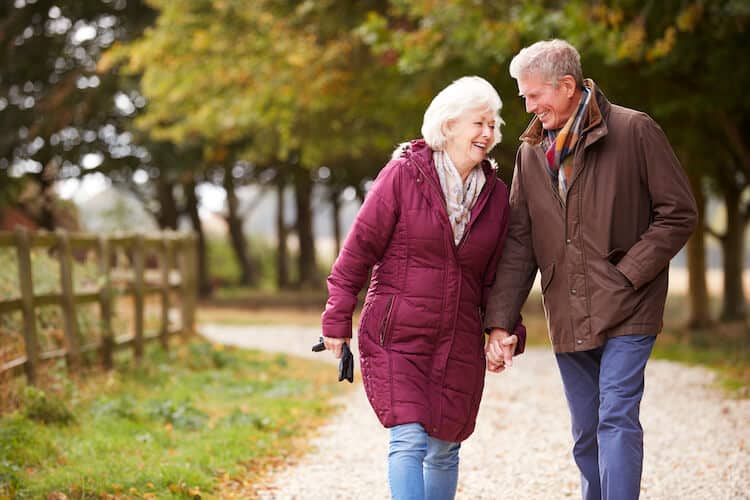 Active senior couple taking a walk in the park.