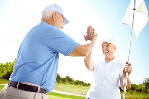 Seniors on the golf course enjoying a financially secure retirement
