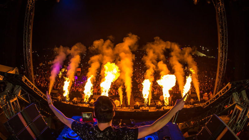 Martin Garrix performing on main stage with pyro