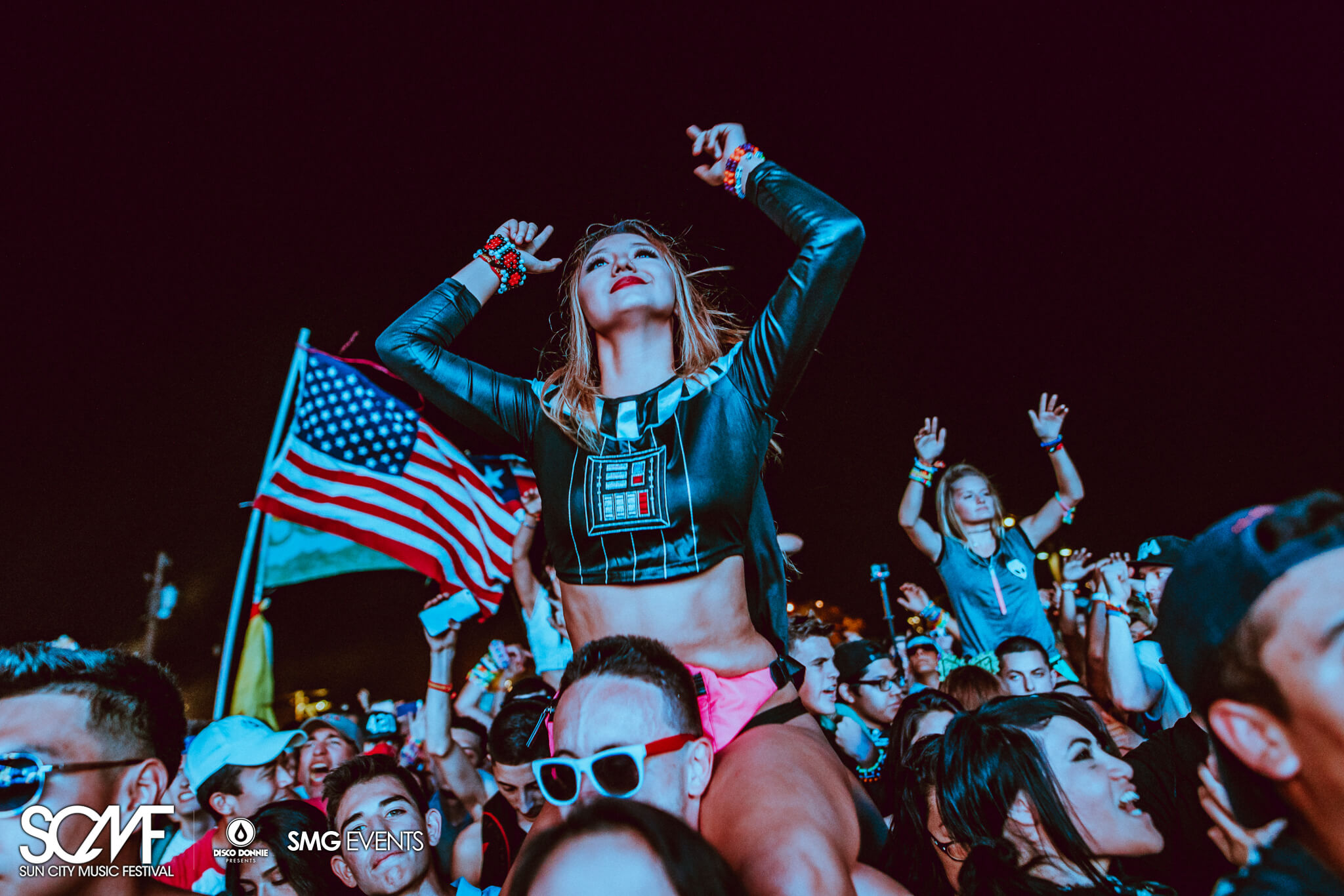 girl on guys shoulder with american flag