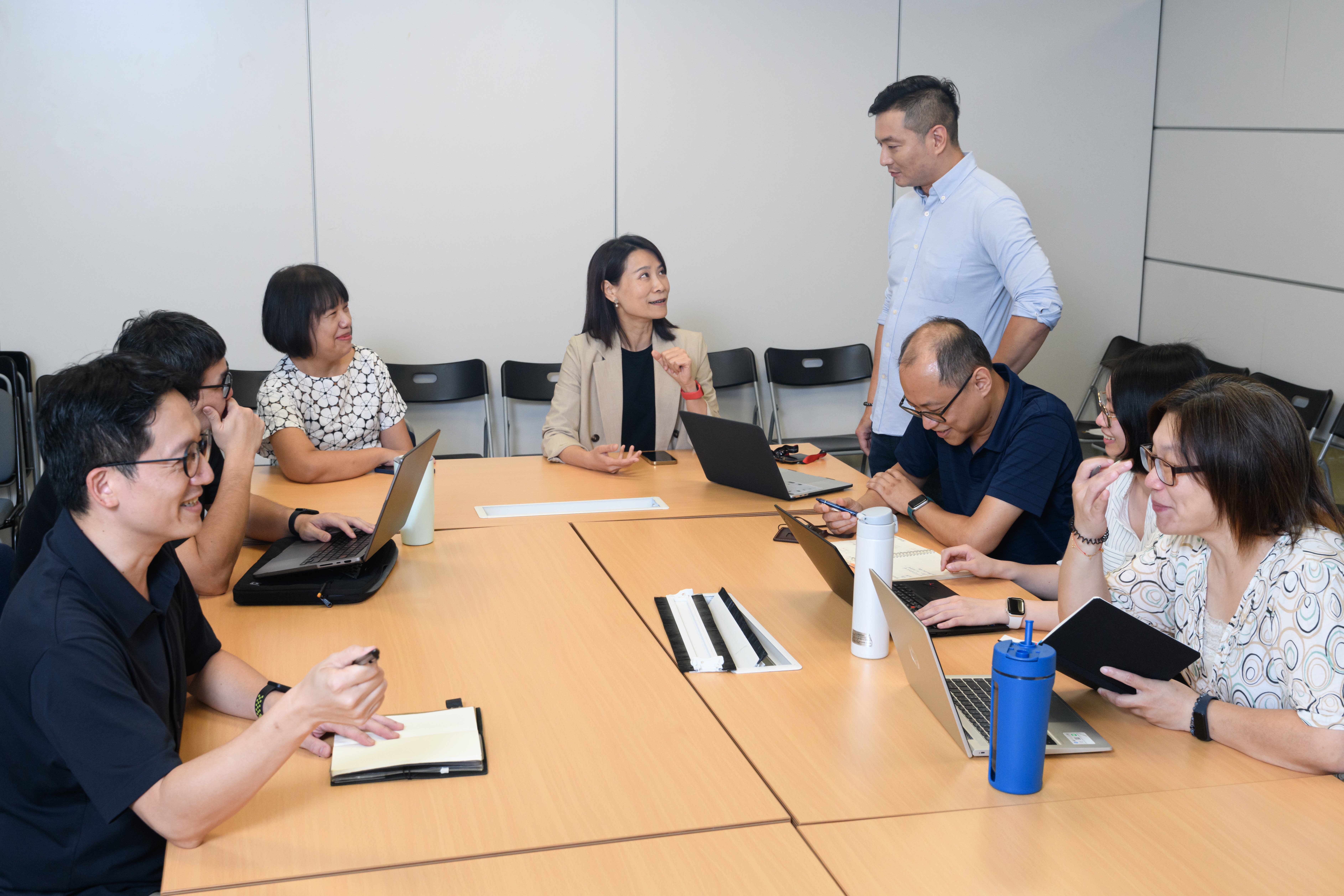 CommonWealth Magazine team has a discussion in a board room