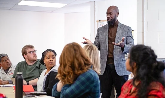 Derrick Cain, Community Engagement Editor for Resolve Philadelphia, speaks to a small group