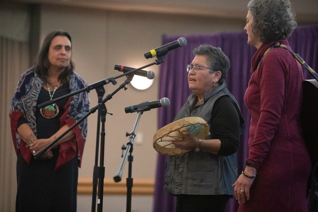 Three members of the Minnesota Women’s Press Gala talk into microphones on stage