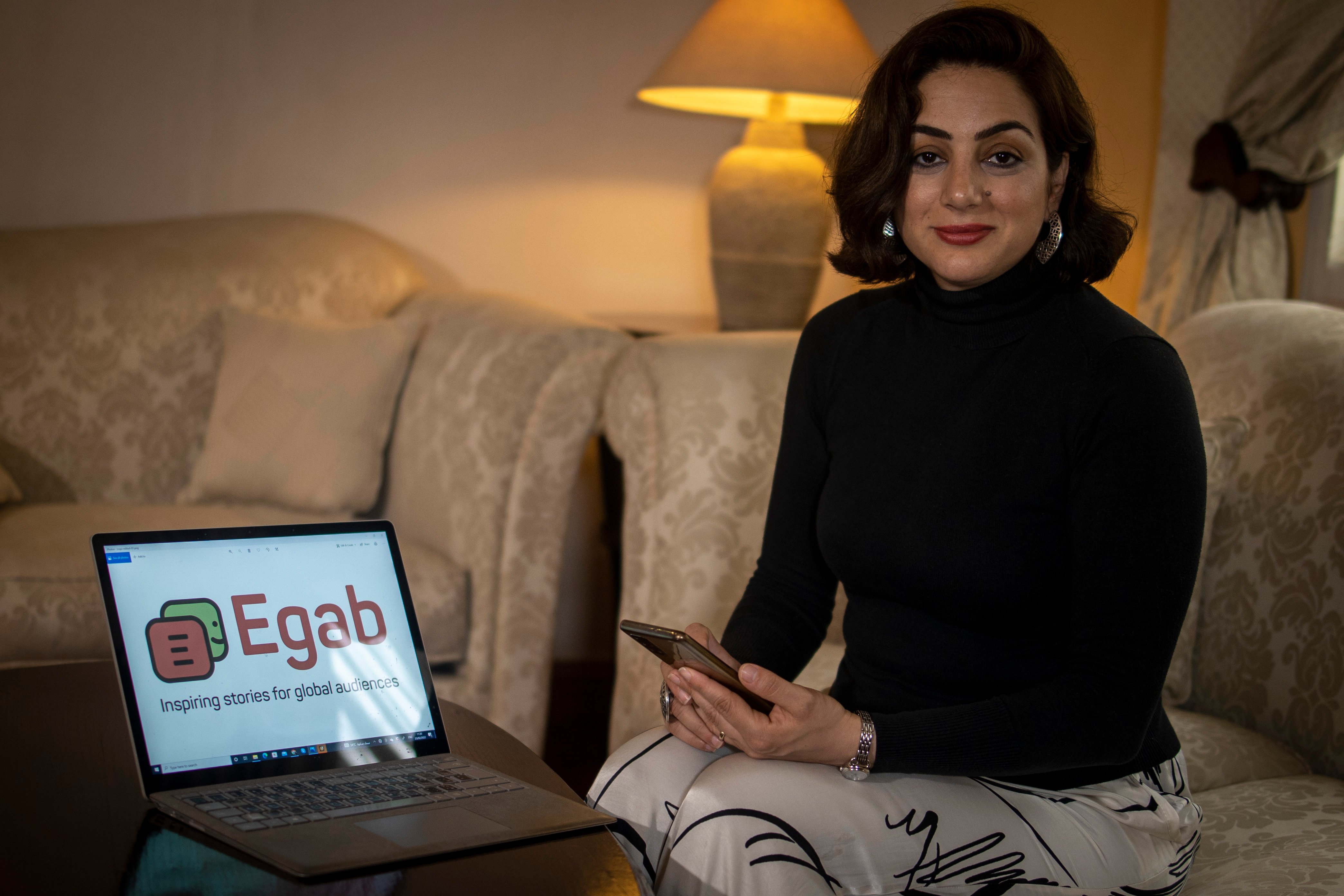 Dina Aboughazal takes a Headshot with Egab's Logo