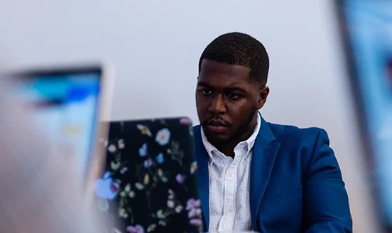 Reporter Jalon Hill works on his laptop in the QCity Metro office