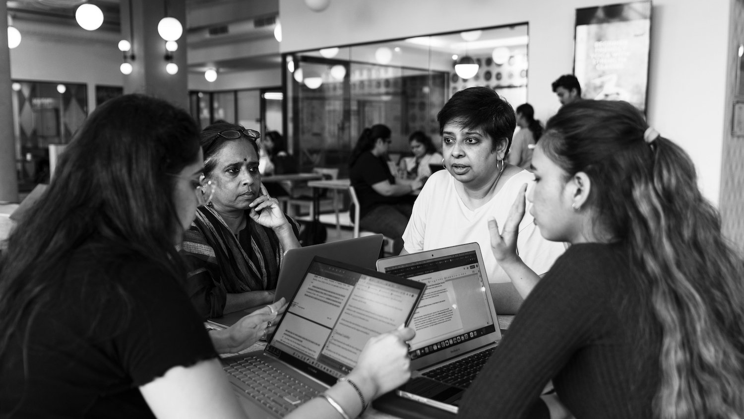 BehanBox employees having a discussion in black and white