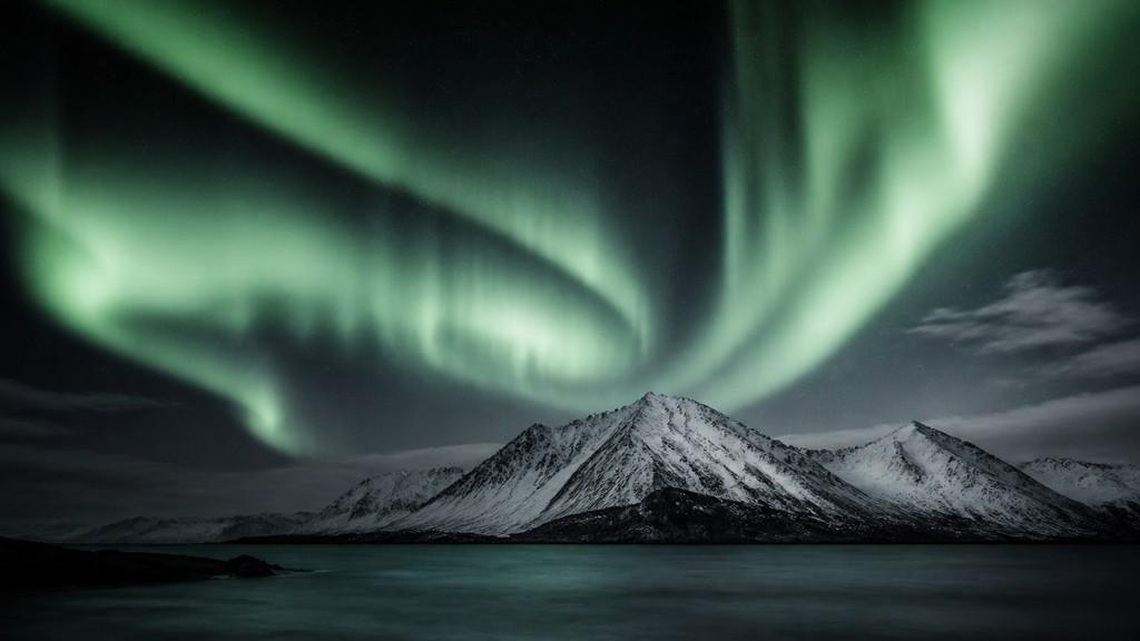 a flowing aurora over snowy peaks, wide sweeping composition, no people, no text — Fine Art Photography Style banner