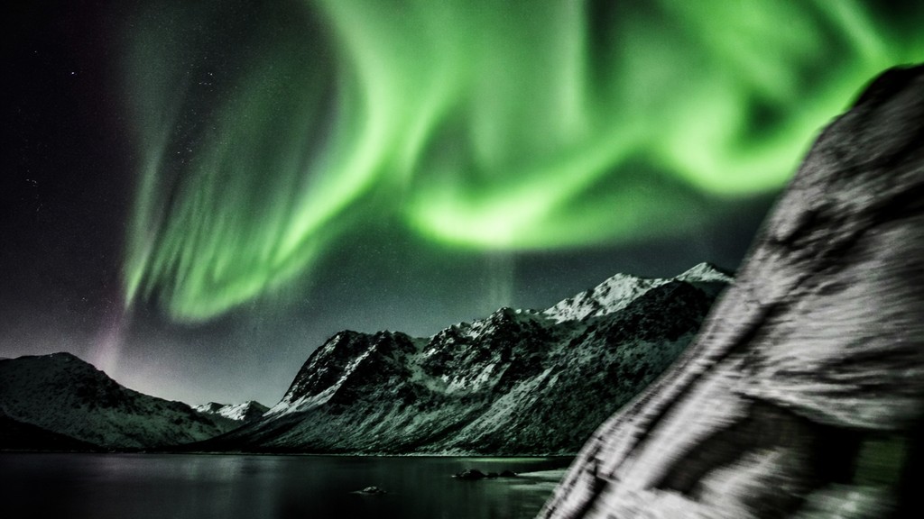 a flowing aurora over snowy peaks, wide sweeping composition, no people, no text — Performance Art Style banner
