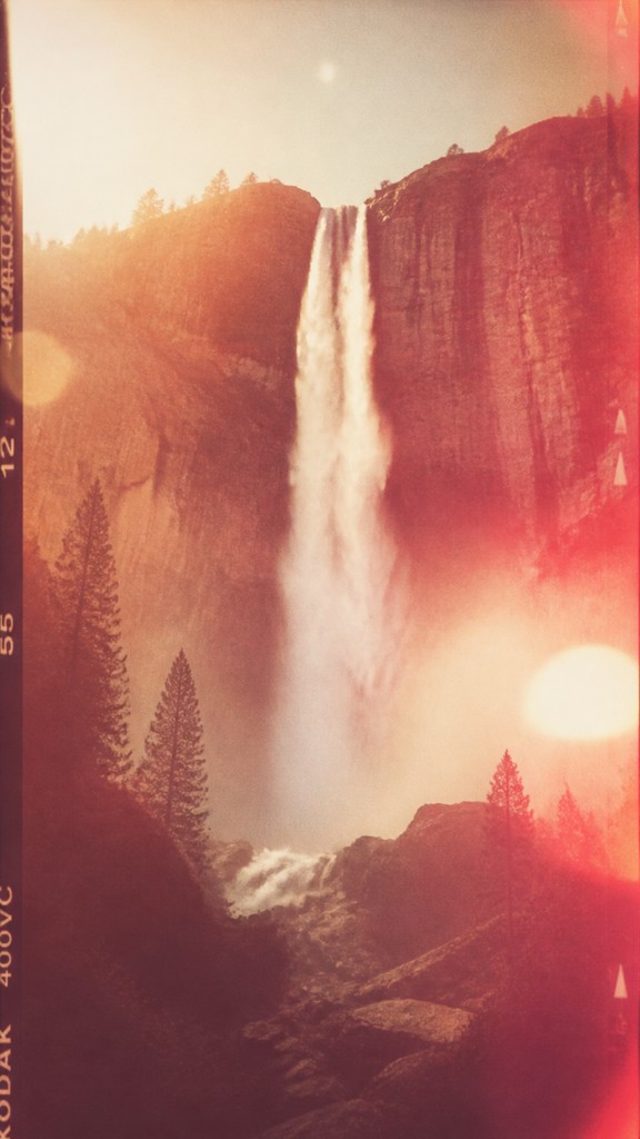 towering waterfall cascading down a cliff — Vintage Film Burn