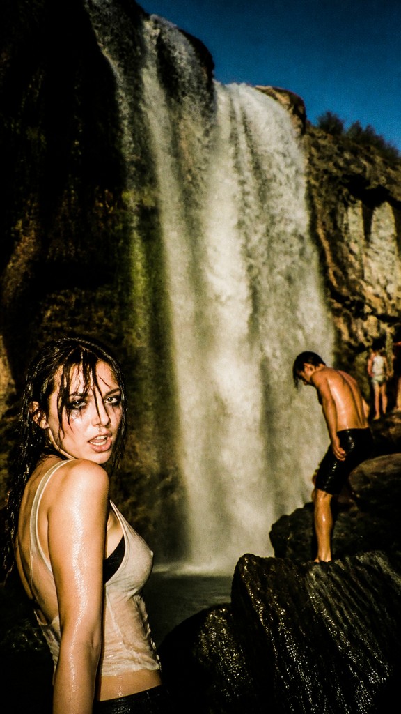 towering waterfall cascading down a cliff — Indie Sleaze Aesthetic