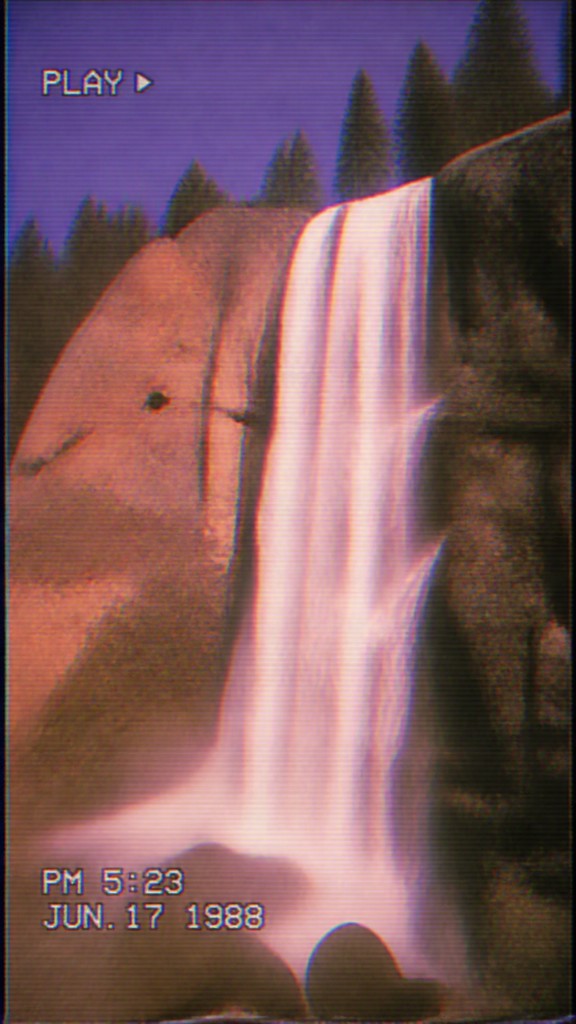 towering waterfall cascading down a cliff — VHS Aesthetic