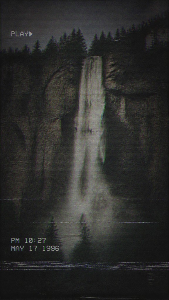 towering waterfall cascading down a cliff — Analog Horror Aesthetic