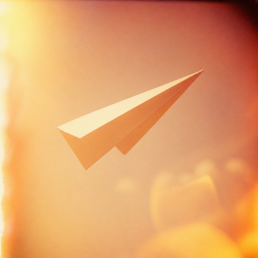 a paper plane, clean minimal composition on a plain background, no text — Vintage Film Burn icon