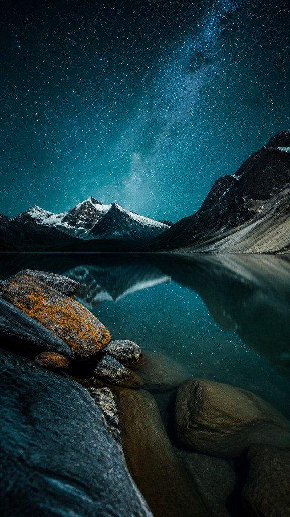 a tranquil mountain lake beneath a starry night sky, no people, no text — High Fashion Photography Style phone wallpaper