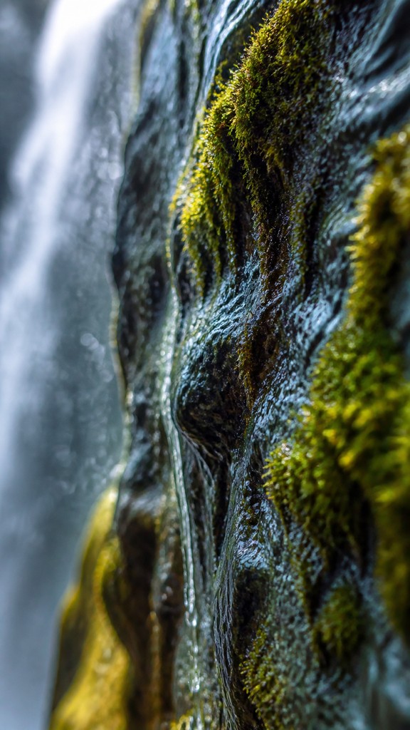 towering waterfall cascading down a cliff — Macro Photography Style